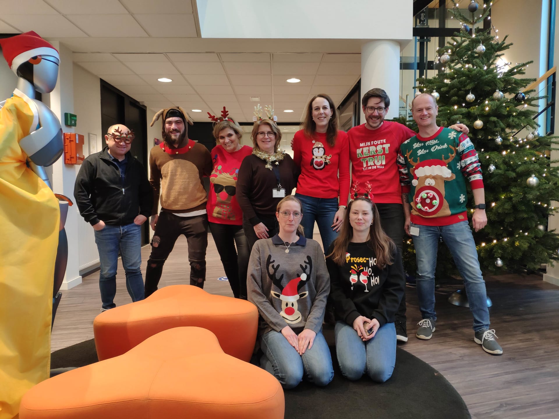 Operations team in front of a Christmas tree