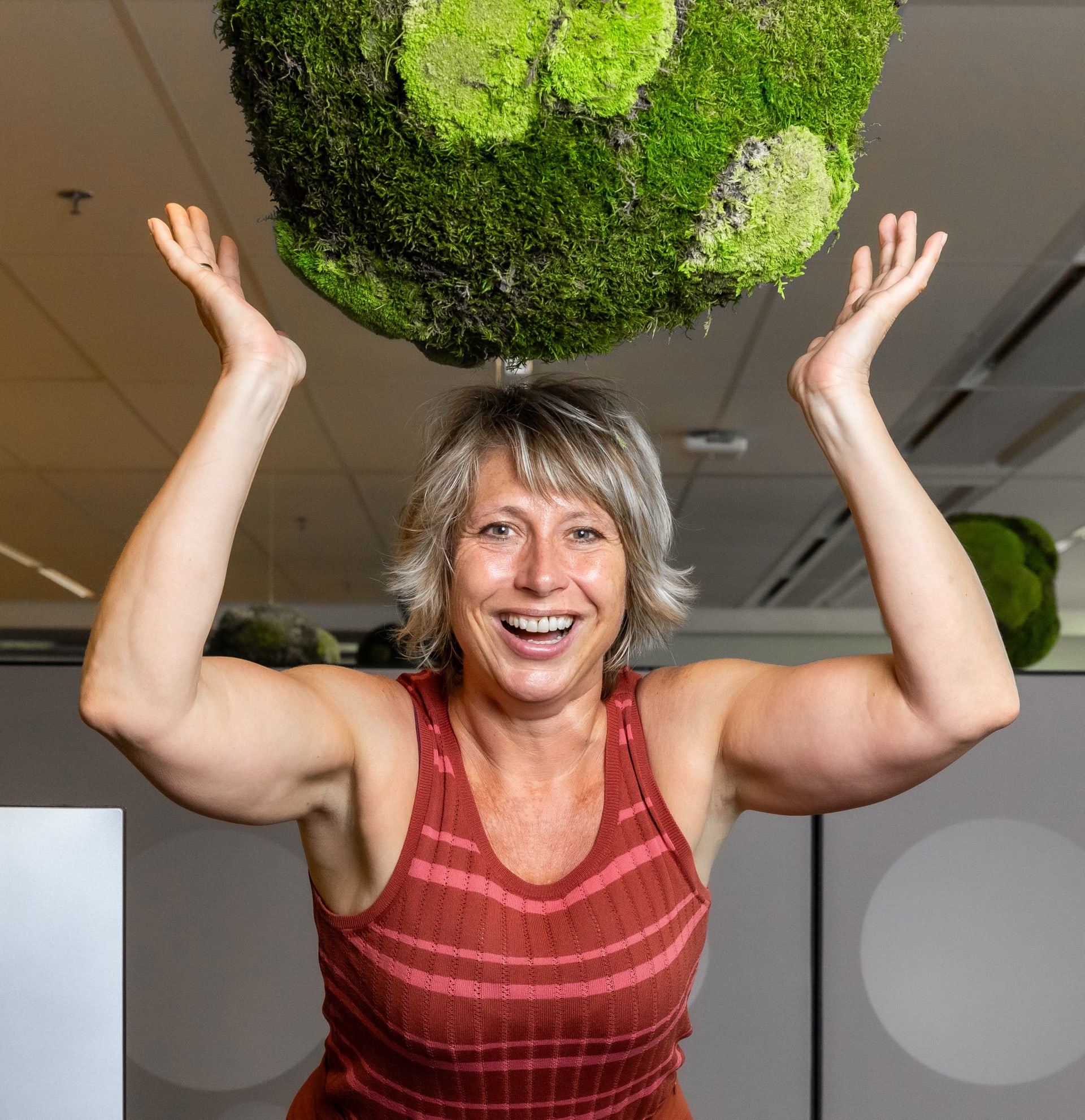 Woman holding a green globe