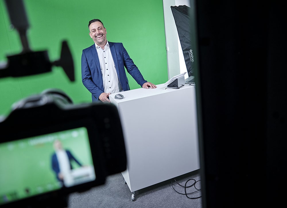 Eine Kollegin und ein Kollege im Empfangsbereich von ECON TEL. Die Kollegin hält ein Tablet in der Hand, auf welches beide interessiert blicken.