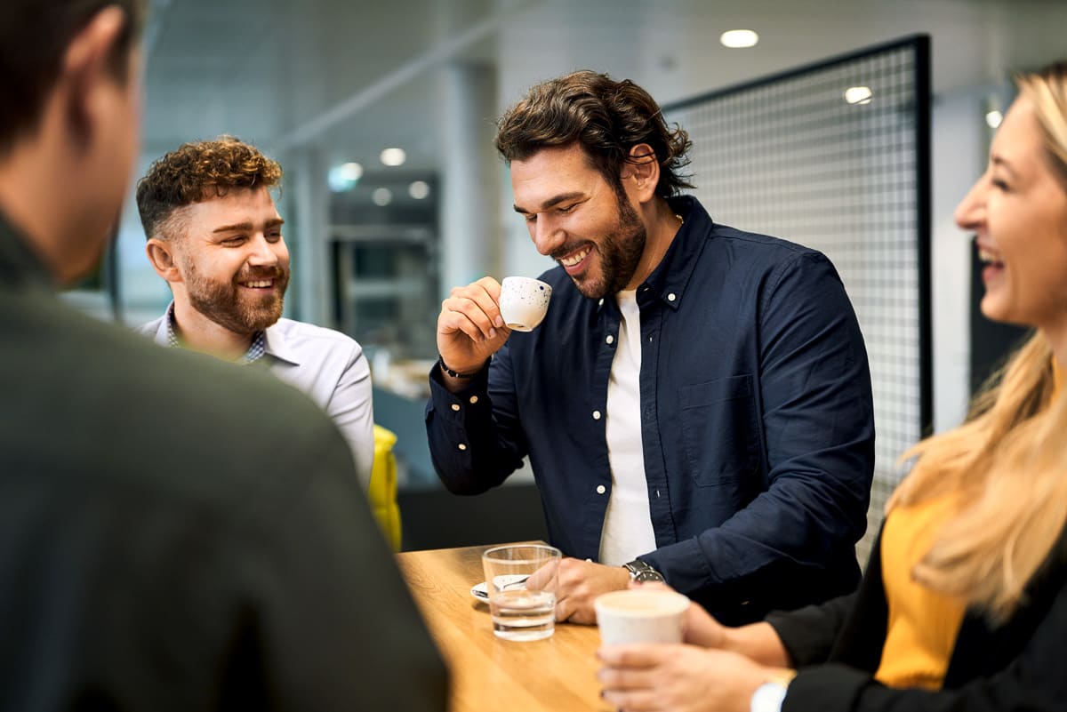 Eine Menschengruppe beim Kaffee trinken an einer Kaffeebar.