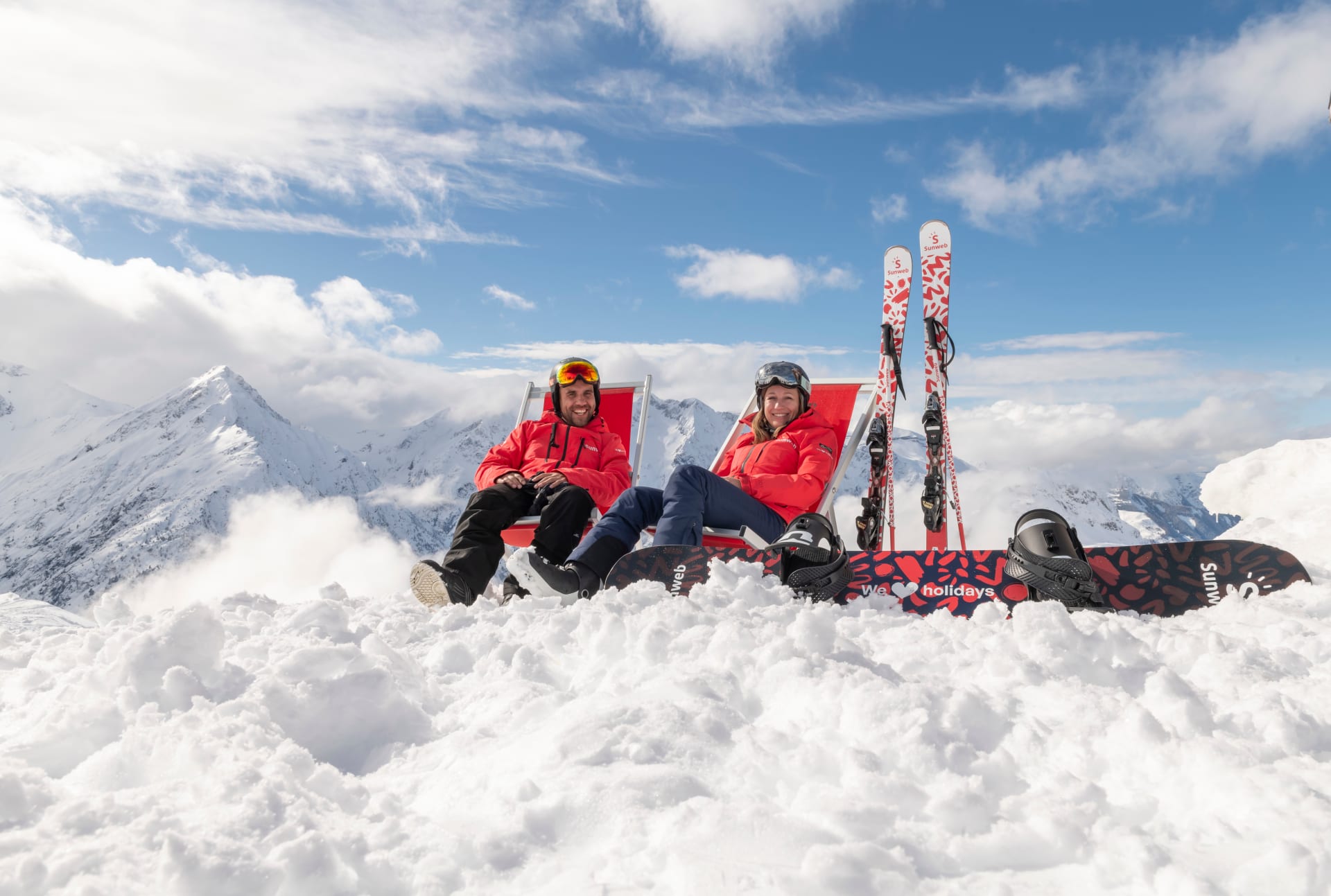 Winter guides on top of a snowy mountain with their ski and snowboard