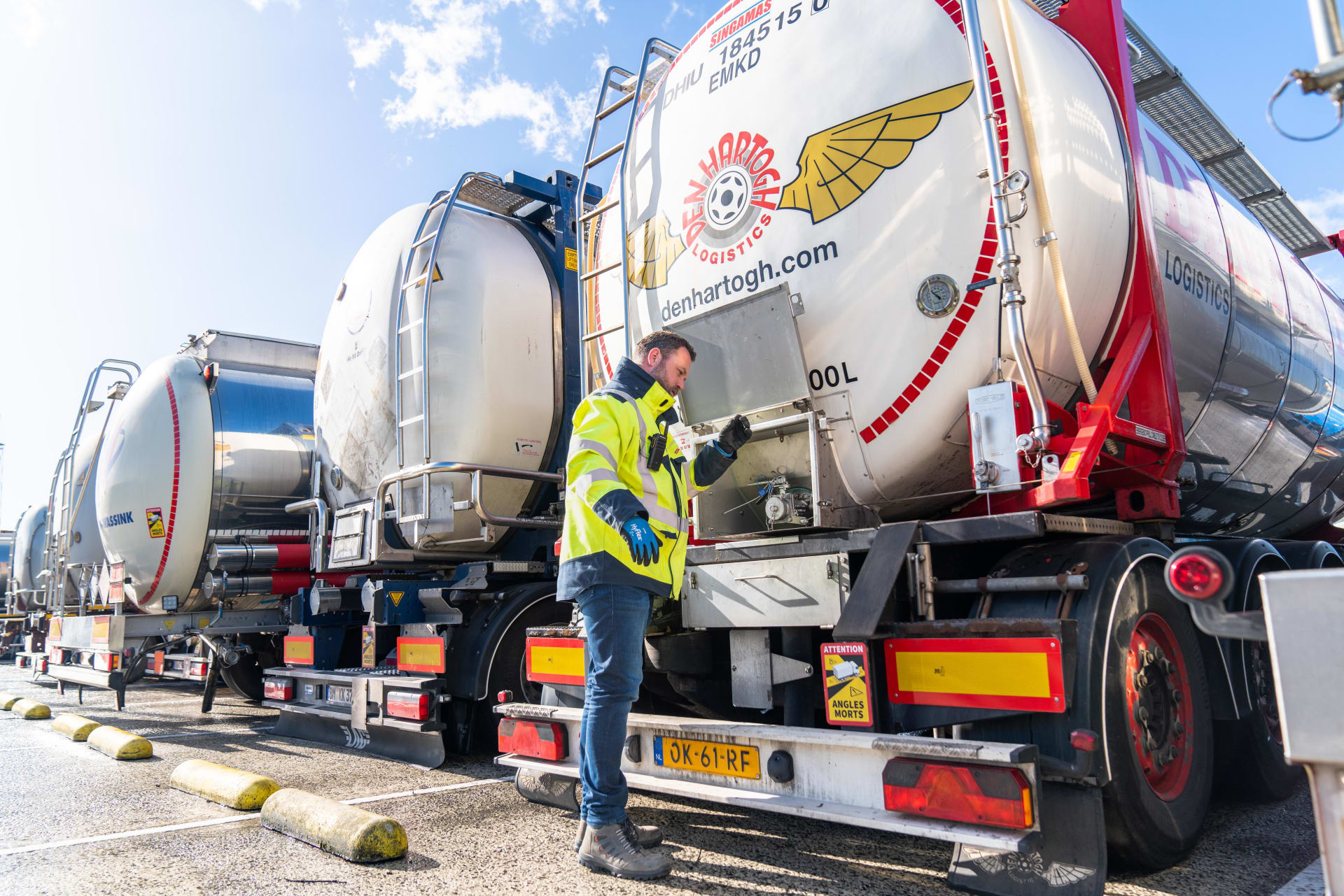 Person standing behind a truck inspecting it