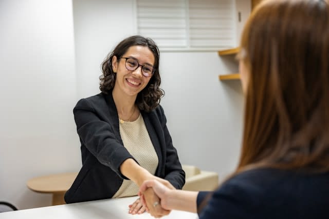 Lady smiling and shaking hands