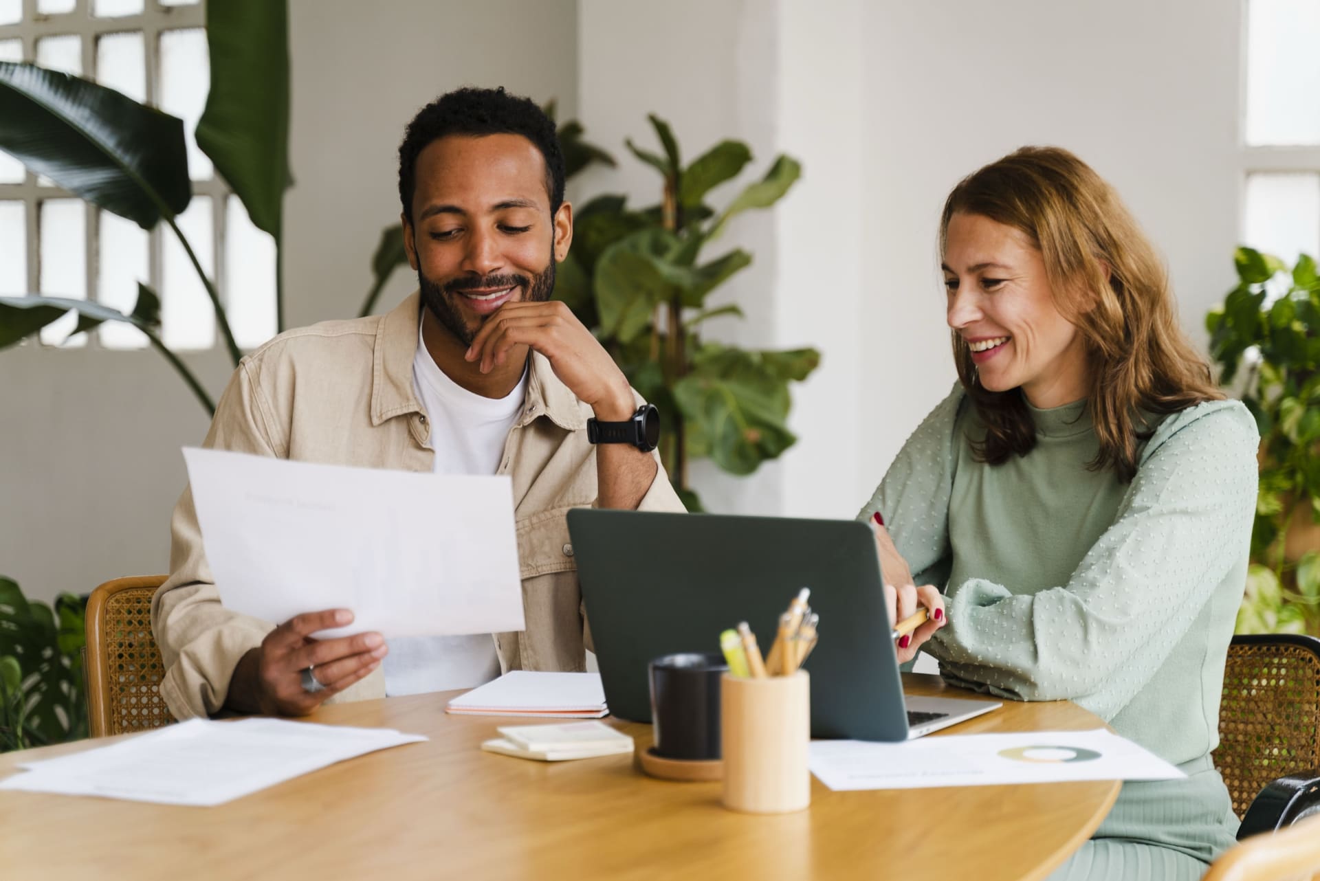 Woman and man smiling at desk