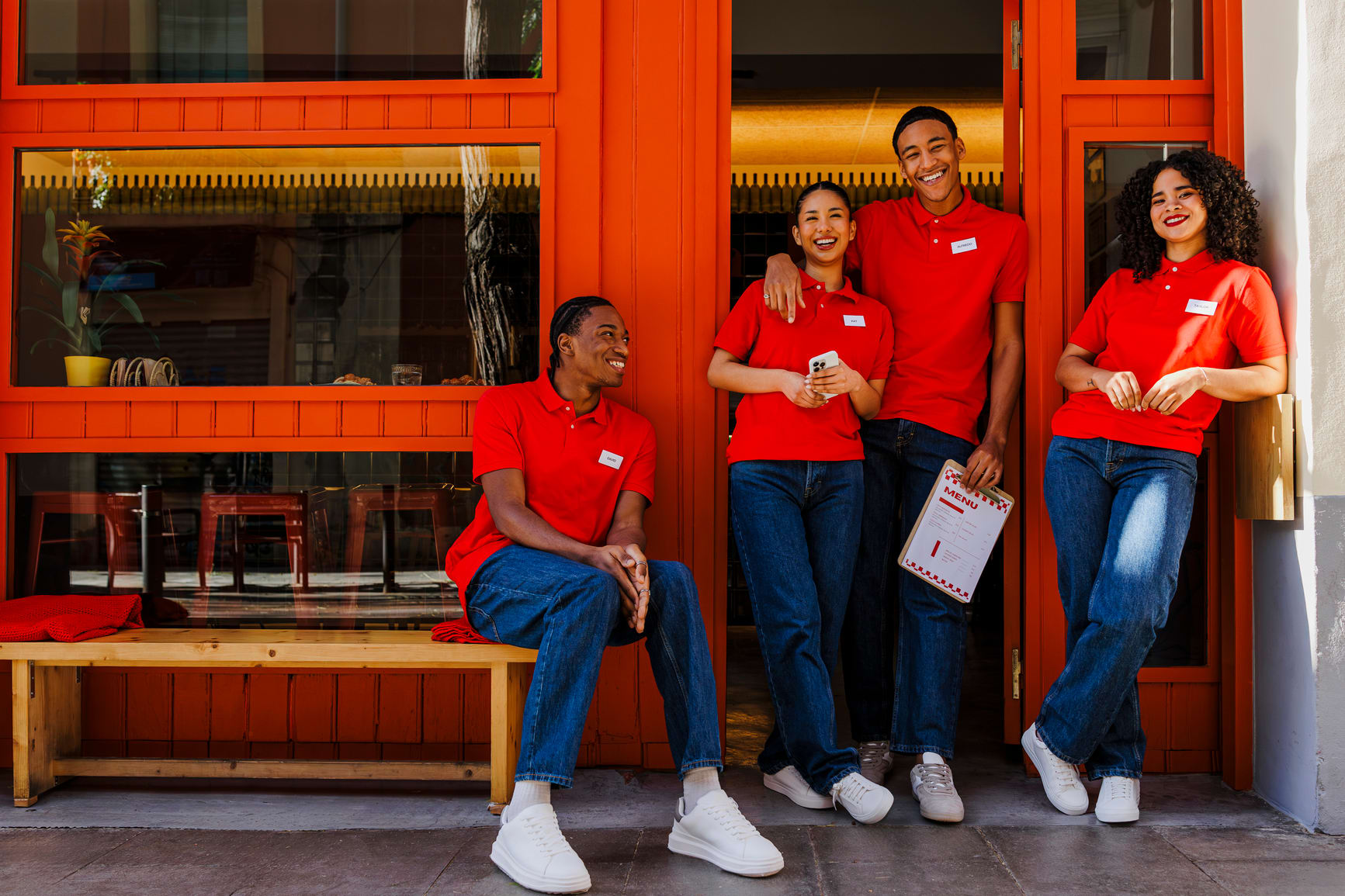 Four happy waitors in red