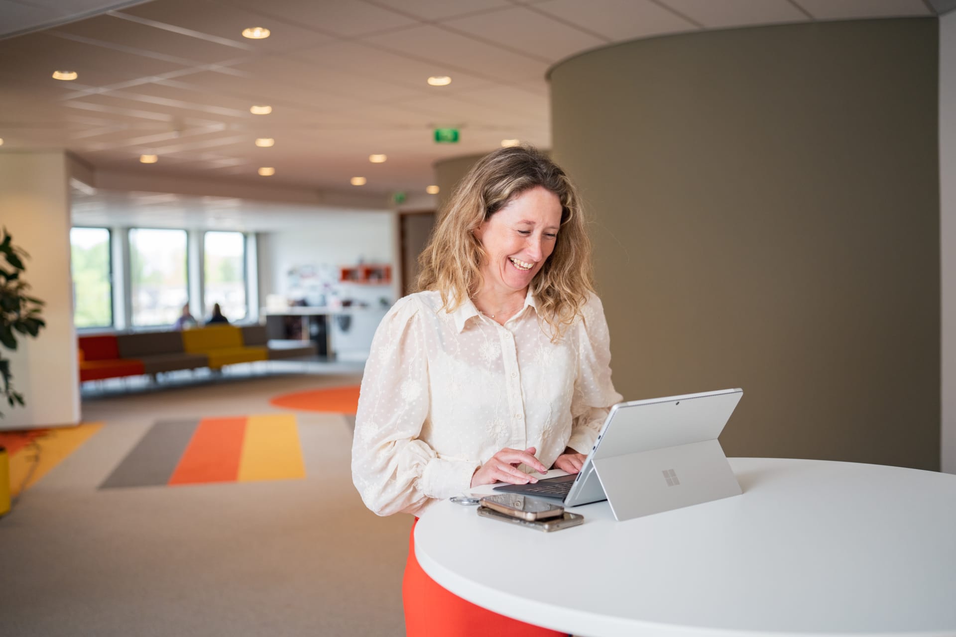 Collega glimlachend naar computerscherm