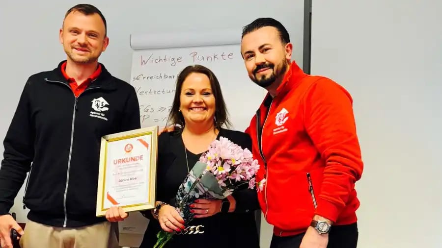 Group photo of three team members standing together, with Team Lead Janine Rice holding her certificate to mark her 5-year anniversary.