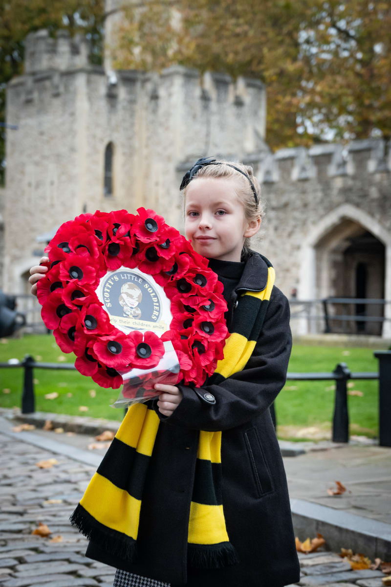 Scotty member holding the poppy wreath at Remembrance parade